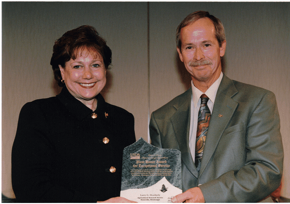 Receiving Plow Award from Agriculture Secretary Ann Veneman